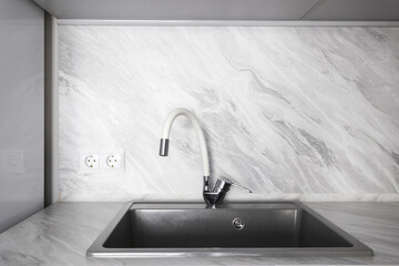 kitchen faucet on a stylish metal sink