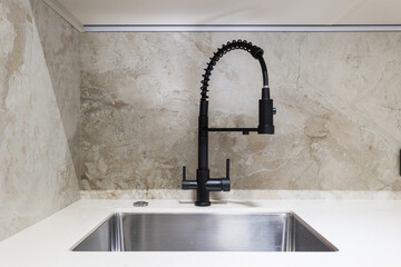 kitchen faucet on a stylish metal sink