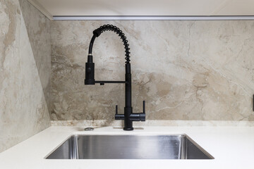 kitchen faucet on a stylish metal sink