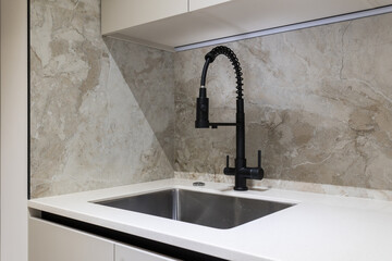 kitchen faucet on a stylish metal sink
