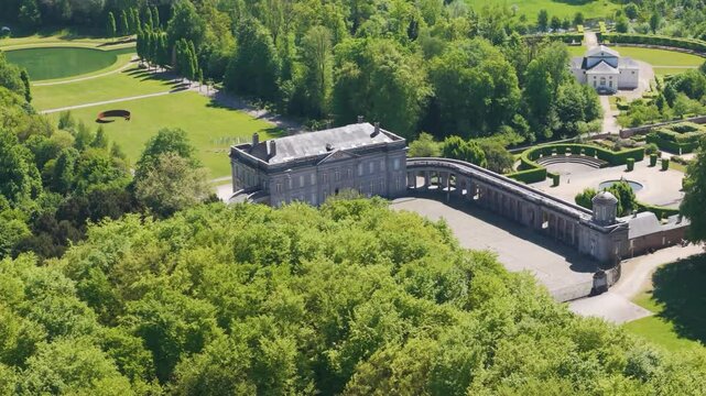 complete compound ch&acirc;teau seneffe scene includes green cover trees serene pond enhancing natural estate revealing left to right pans aerial of de belgium 