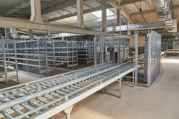 Automated Roller Conveyor in Warehouse Aisle