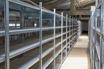 Empty Metal Shelving Units in Warehouse Aisle