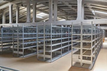 Empty Metal Shelving Units in Warehouse Aisle