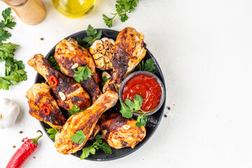 Grilled chicken legs with garlic, spices, parsley, bbq sauce and olive oil