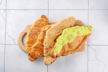 Set of colorful trendy flat croissant with different topping and