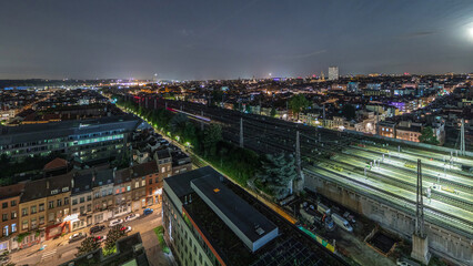 Fototapeta premium Aerial night timelapse of Brussels North station railway tracks with trains arriving and departing. Belgium