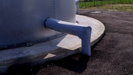 Water storage tank with a connected water pump, showcasing industrial design and functionality, providing essential resources for rural communities and enhancing local infrastructure