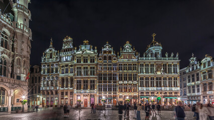 Night hyperlapse of the illuminated Grand Place Guilds facade in Brussels, Belgium.