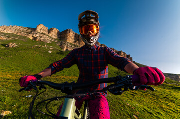Wide angle shot of man wearing full face helmet looking straight at camera against clear blue sky...
