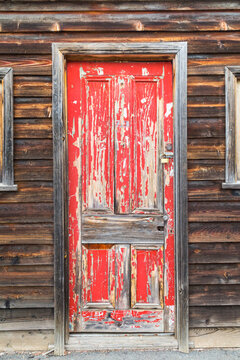 A rustic red door
