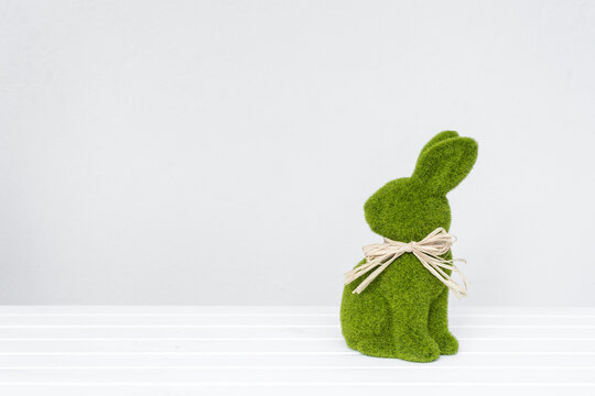 Green easter bunny against a plain background