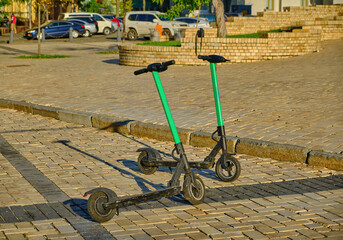 Two Electric Scooters Parked in a City Square