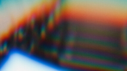 Soft abstract gradient with rainbow hues fading into each other, featuring a textured grain overlay for a retro analog film effect. Blurred lines and colorful transitions create a dreamy visual.