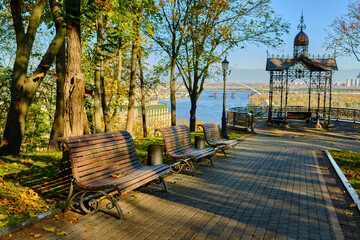 Sunny Autumn Park with Benches and Lampposts