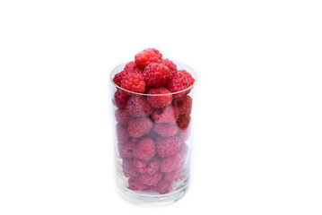 Fresh raspberries in a clear glass glass, isolated on a white background.