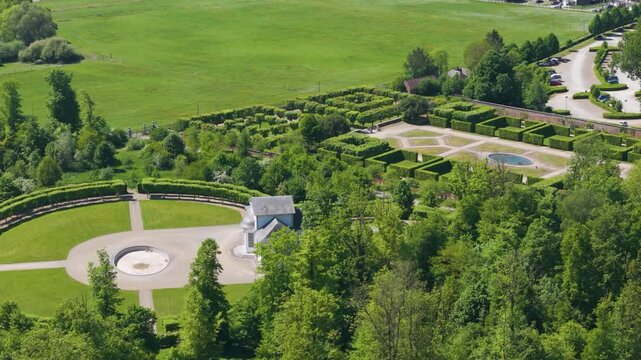 green areas surrounding ch&acirc;teau seneffe along dry ponds parked cars indicate site's accessibility popularity among visitors left to right pans aerial drone of 