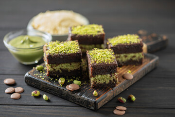 Trend dessert. Dubai Brownies. Chocolate muffin with a layer of pistachio paste and kataifi dough
