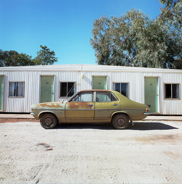 Old rusty car outside outback cabins