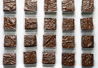 Freshly Baked Brownie with Crinkled Top in Gloved Hand