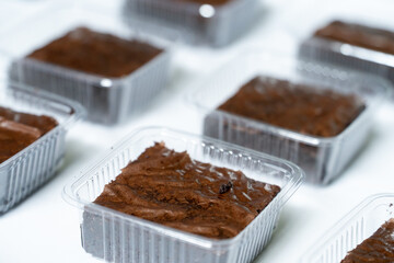 Row of Delicious Chocolate Brownies in Retail Containers