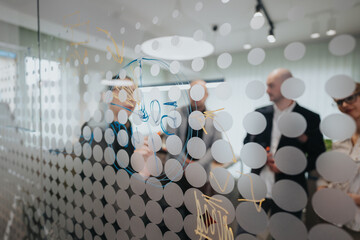 Colleagues in a modern workspace brainstorming ideas and discussing strategies while surrounding a...