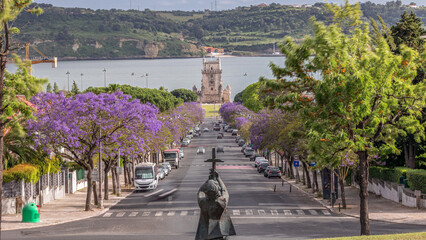 View of Avenida Torre de Belem timelapse, with cars and the Belem Tower in the background. Lisbon,...