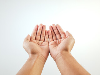A gesture of two open hands shown together in a gesture of offering, giving, or prayer, isolated on a white background.