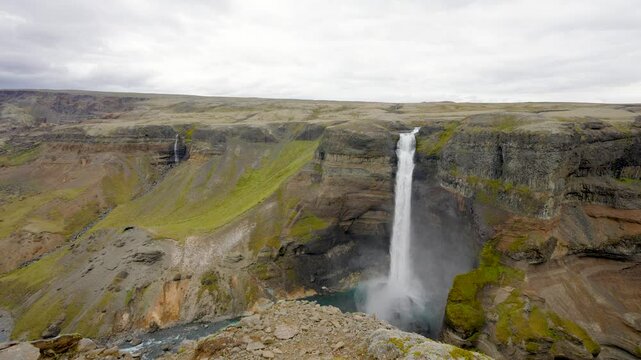 A majestic view of both Haifoss and Granni waterfalls in Iceland, showcasing their powerful twin cascades plunging into a dramatic canyon.