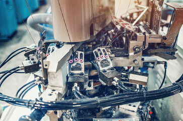 Part of sock production machine. Sock factory, automated process of automatic sock production.