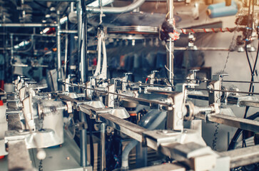Industrial type of socks production. Sock factory, automated process of automatic socks production.