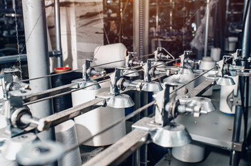 Industrial type of socks production. Sock factory, automated process of automatic socks production.