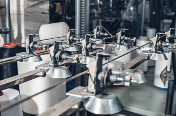 Industrial type of socks production. Sock factory, automated process of automatic socks production.