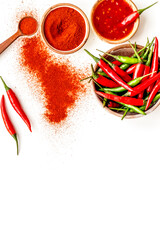Fresh and powdered red and green chilli pepper pattern on white table background top view space for...