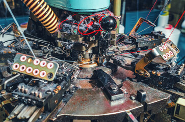 Dust from threads when making socks on knitting machine. Threads, parts, socks production.