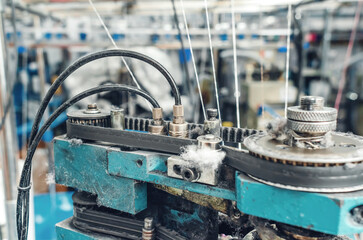 Close-up of industrial circular knitting machine. Textile industry, automatic knitting of socks.