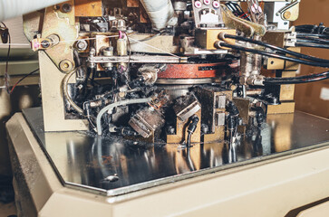 Dust from threads. Image of sock knitting machine in operation. Equipment in textile production.