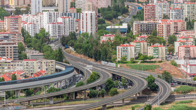 Aerial top view of highway multilevel junction road in urban populated area timelapse.