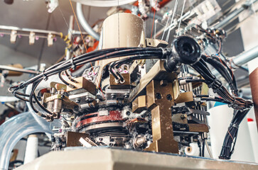 Socks production on knitting machine. Threads, parts, socks production. Dust from threads.