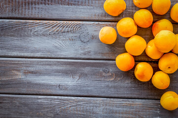 Fruit background with apricots on dark wooden background top view copy space
