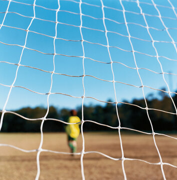 Soccer Football net with blurry goal keeper