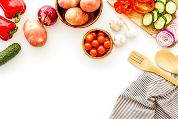 Set of autumn vegetables - potato, cucumber, carrot, greenery - on white background copy space