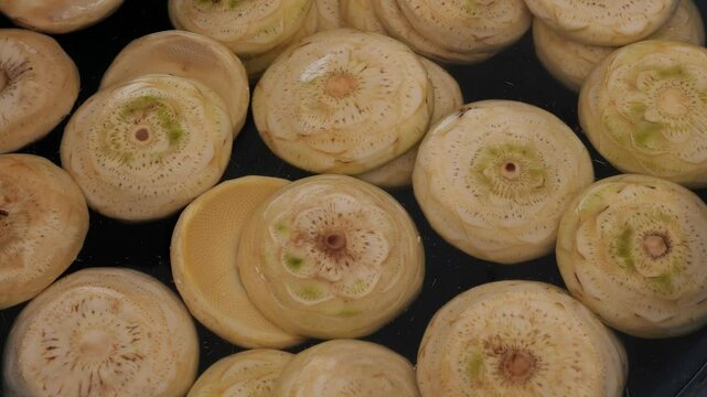 Peeled artichokes in plastic bowl at local market