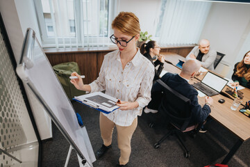 Business colleagues discussing strategies and ideas in a conference room, enhancing teamwork...