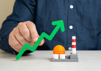 Green arrow up and energy plant. Growth of chemical or energy sector of the economy. Investment...