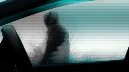 A glitch horror concept. Inside a car. Looking up at a mysterious scary hooded figure outside on a spooky wet rainy winters day
