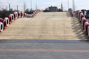 A slope featuring vibrant red and white tire barriers, ideal for racing or recreational purposes