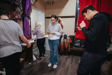 A group of young performers engage in preparations backstage before a theater production,...