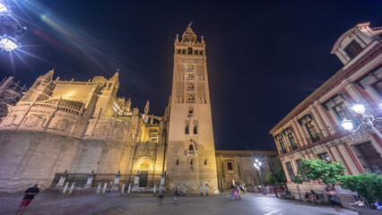 La Giralda and Seville Cathedral timelapse hyperlapse glowing under the night sky.