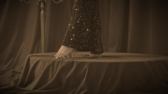 body part, legs feet in silver heeled sandals, high heel shoes. sparkly dress Retro lady sexy woman fashion model posing, old roar style 20s 30s years. girl standing on stage scene film sepia color